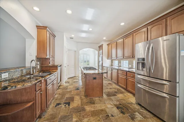 a kitchen with a refrigerator and a sink