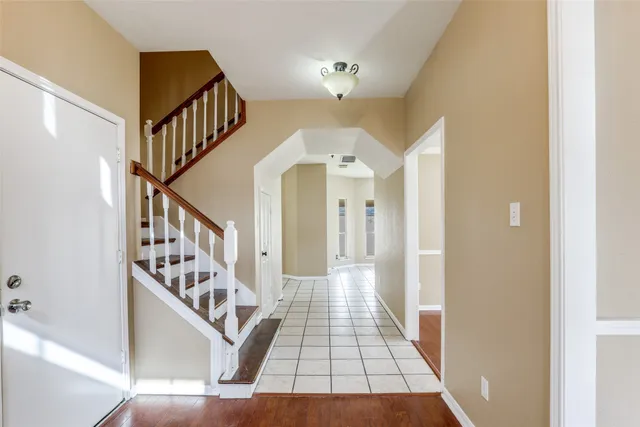 a view of entryway and hall with wooden floor