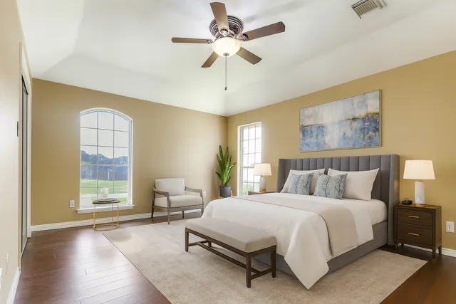a spacious bedroom with a bed and a chandelier