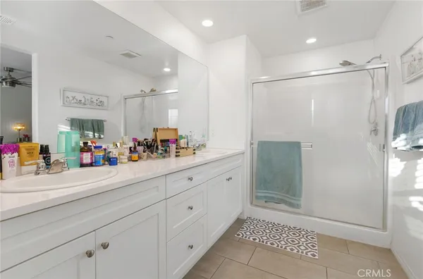 a bathroom with a shower sink and mirror