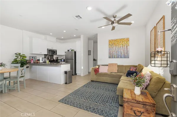a living room with furniture and kitchen view