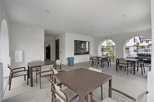 a dining room with furniture a rug and a floor to ceiling window