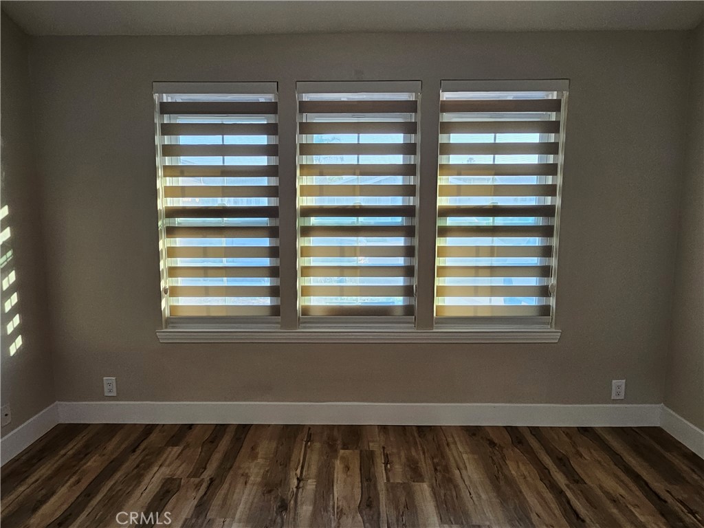 4481 Wyngate Circle Irvine, CA 92604 - Photo 16 of 42 a view of empty room with wooden floor and a window