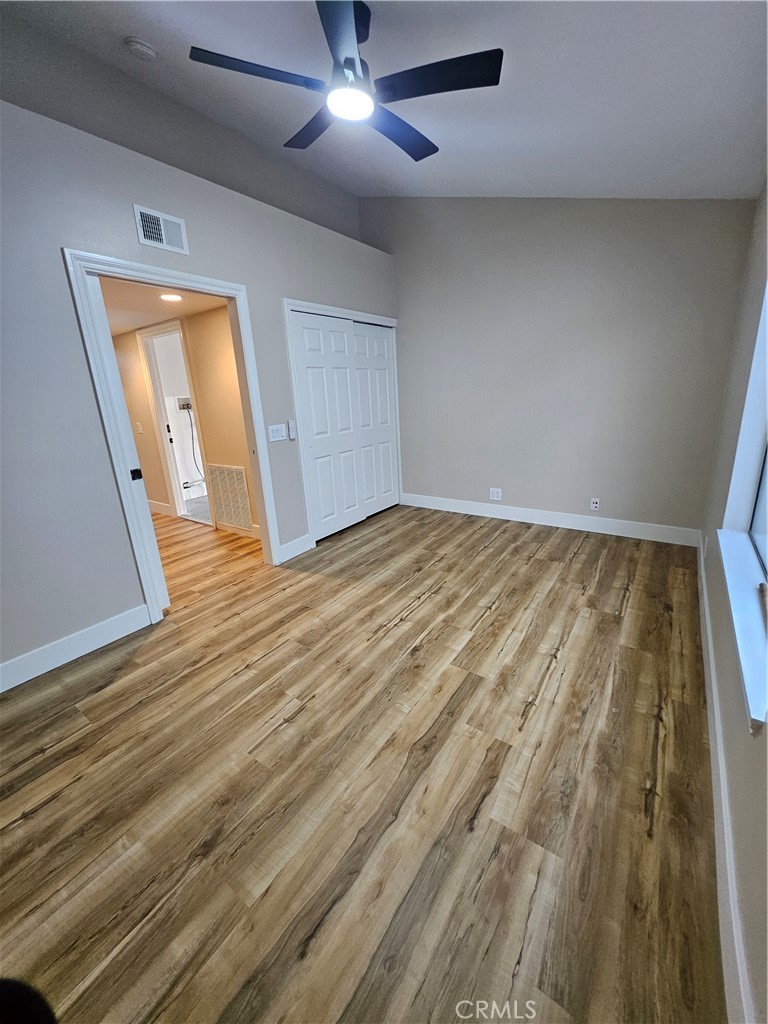 4481 Wyngate Circle Irvine, CA 92604 - Photo 17 of 42 an empty room with wooden floor cabinet and windows