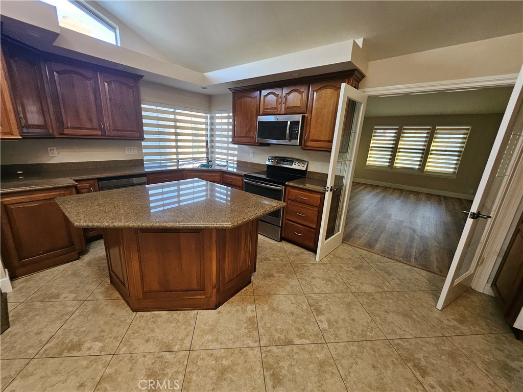 4481 Wyngate Circle Irvine, CA 92604 - Photo 2 of 42 a kitchen with stainless steel appliances granite countertop a stove a sink and a microwave