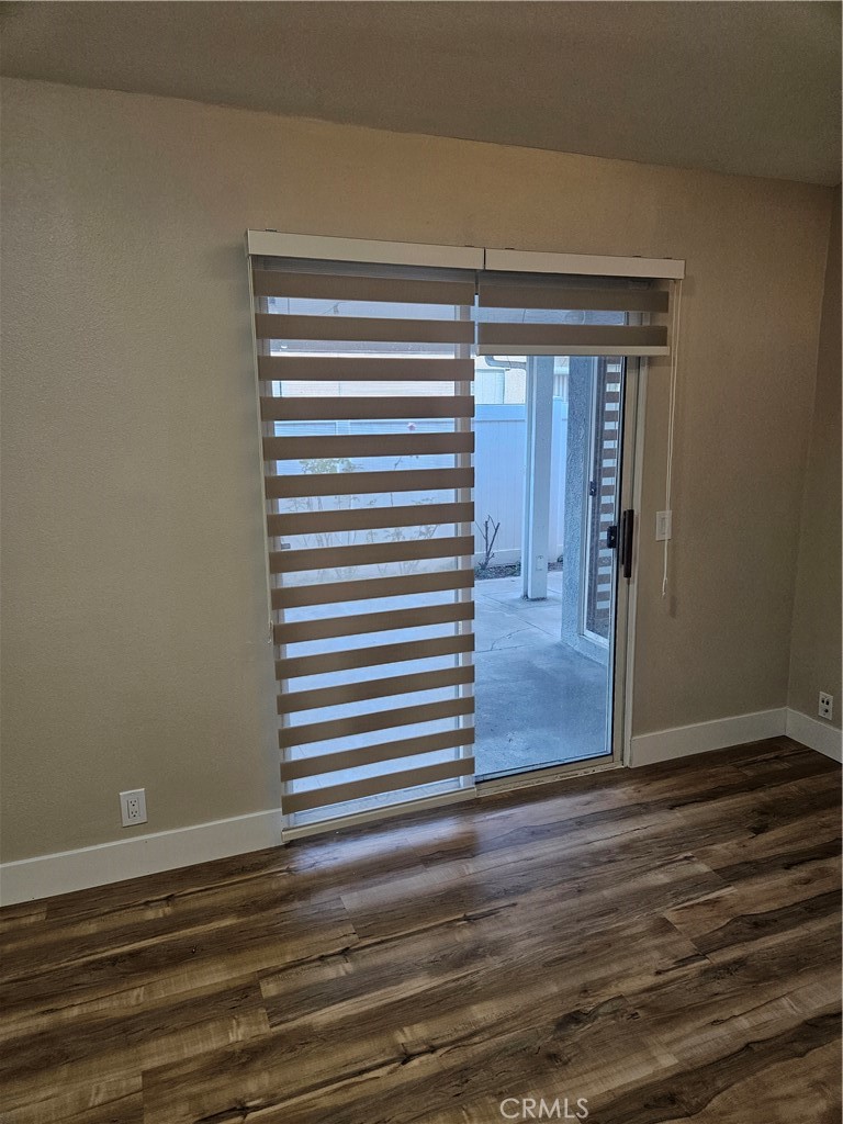 4481 Wyngate Circle Irvine, CA 92604 - Photo 27 of 42 an empty room with wooden floor cabinet and windows