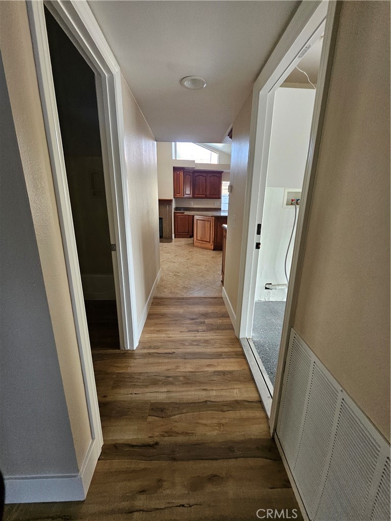 4481 Wyngate Circle Irvine, CA 92604 - Photo 36 of 42 a view of a hallway to a livingroom with wooden floor and staircase