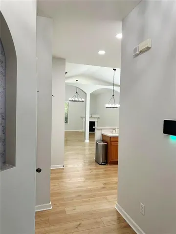 a view of a hallway with wooden floor