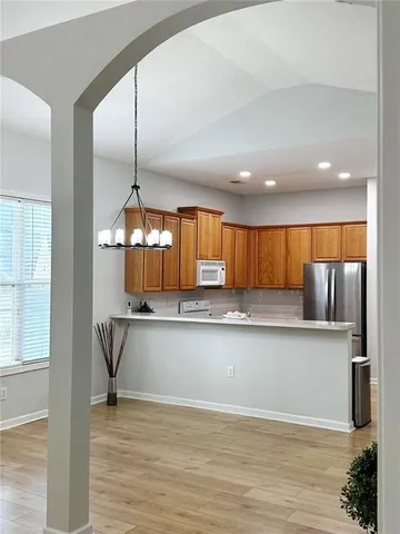 a view of kitchen with microwave and cabinets