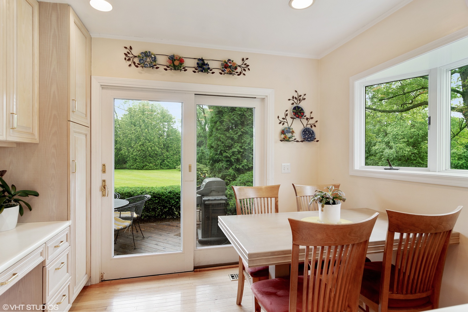 196 Coach Road Northfield, IL 60093 - Photo 11 of 36 a dining room with wooden floor a chandelier a wooden table and chairs