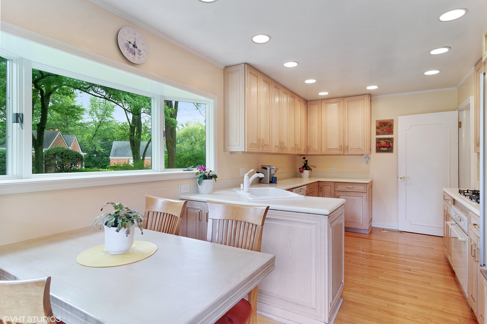 196 Coach Road Northfield, IL 60093 - Photo 12 of 36 a kitchen with stainless steel appliances granite countertop a kitchen island a stove a table and a refrigerator