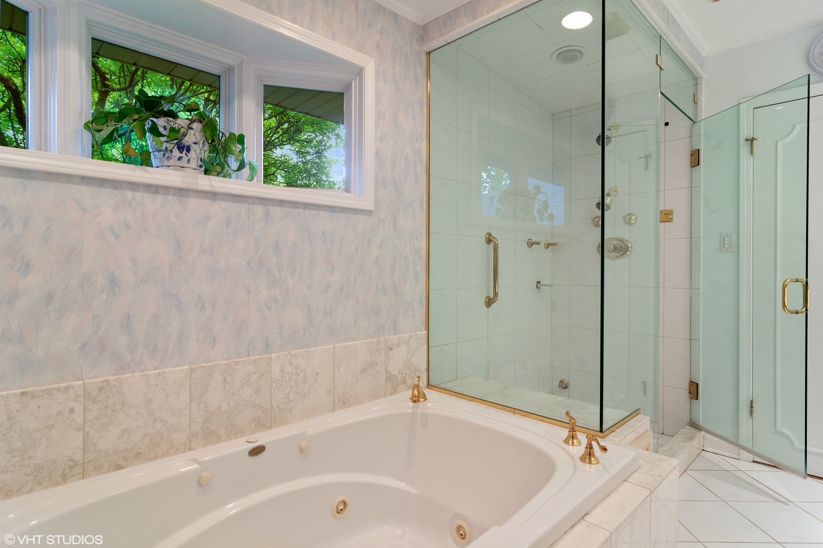 196 Coach Road Northfield, IL 60093 - Photo 18 of 36 a bathroom with a bathtub and a shower