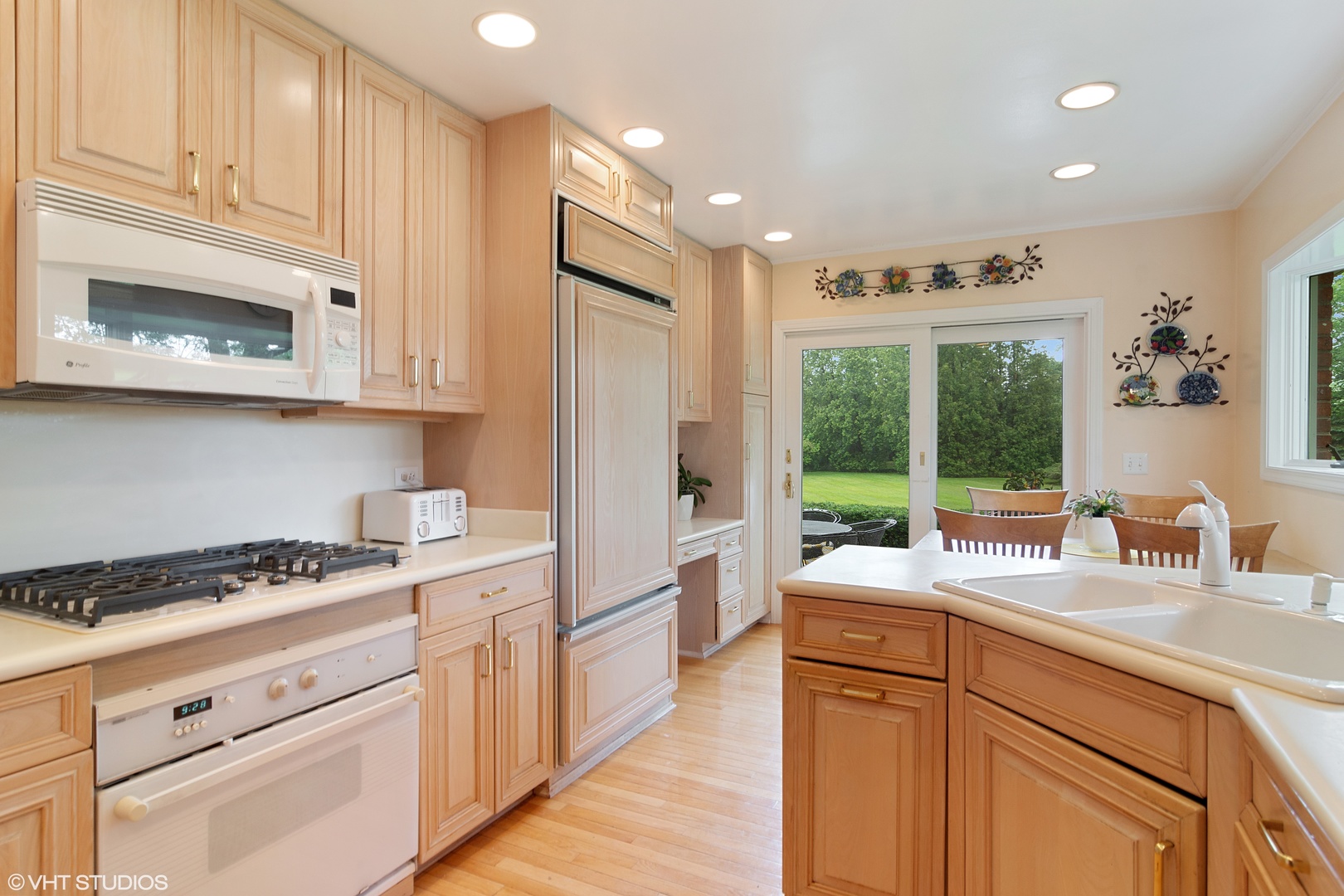 196 Coach Road Northfield, IL 60093 - Photo 8 of 36 a kitchen with stainless steel appliances granite countertop a stove and a white cabinets