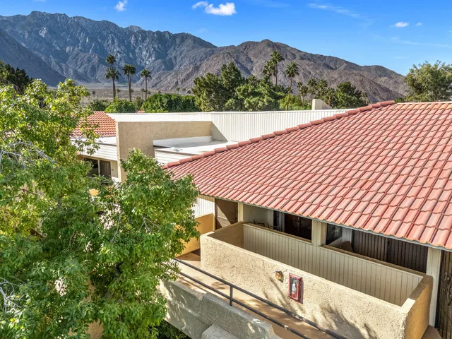a view of a patio with a table under an umbrella