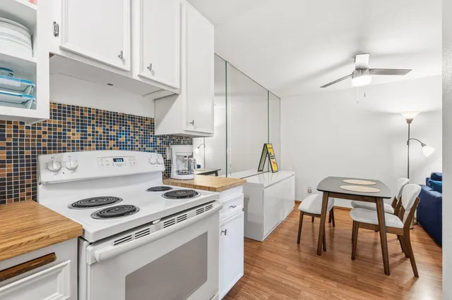 a kitchen with a stove a table and chairs
