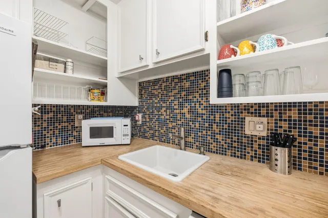 a kitchen with a sink a stove and cabinets