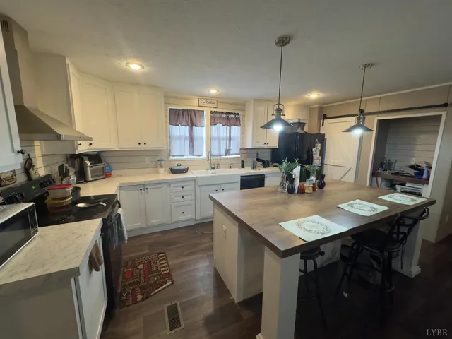 a kitchen with a sink a counter top space and stainless steel appliances