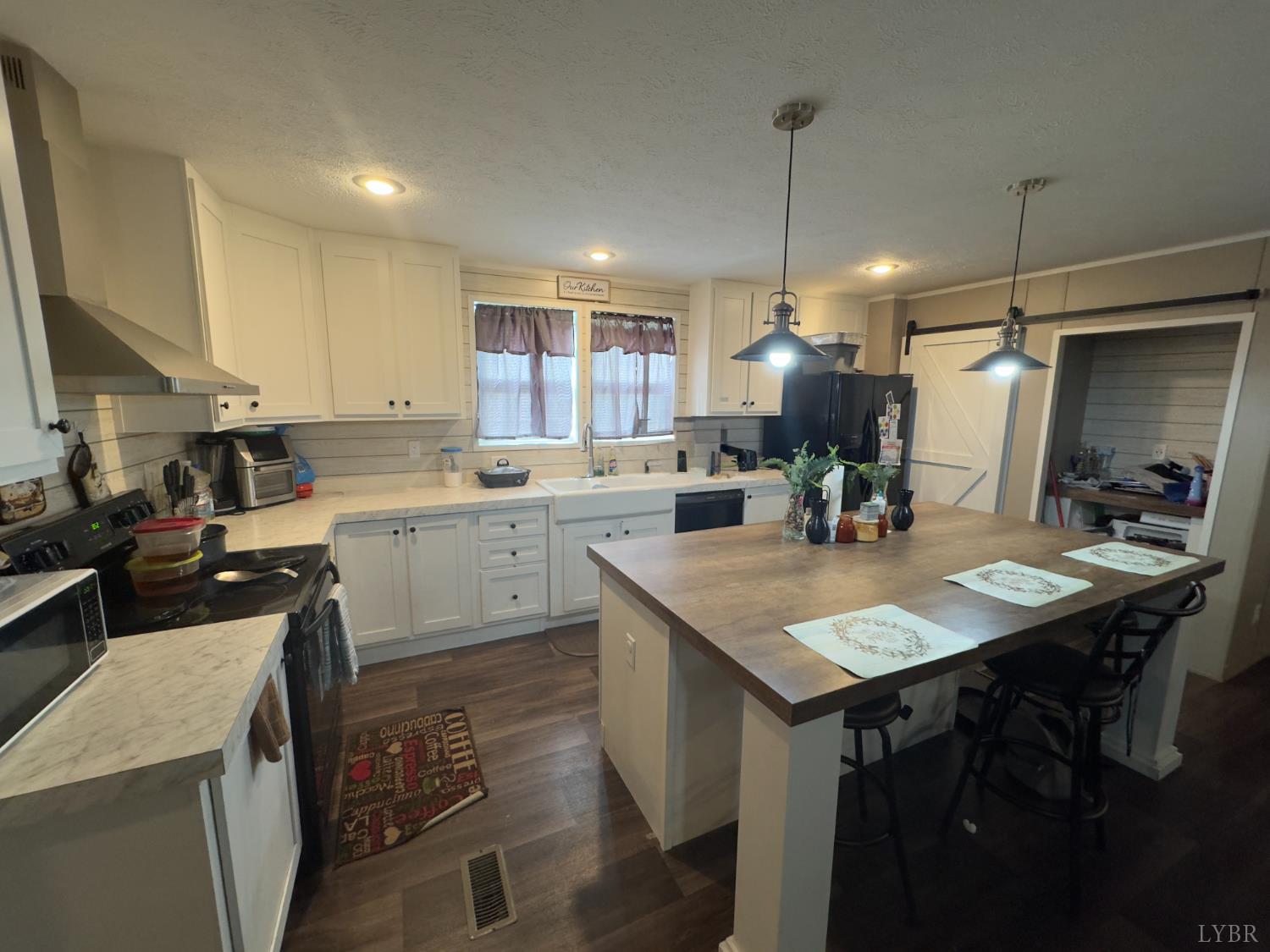 3772 Promise Land Road Appomattox, VA 24522 - Photo 14 of 28 a kitchen with a sink a counter top space and stainless steel appliances