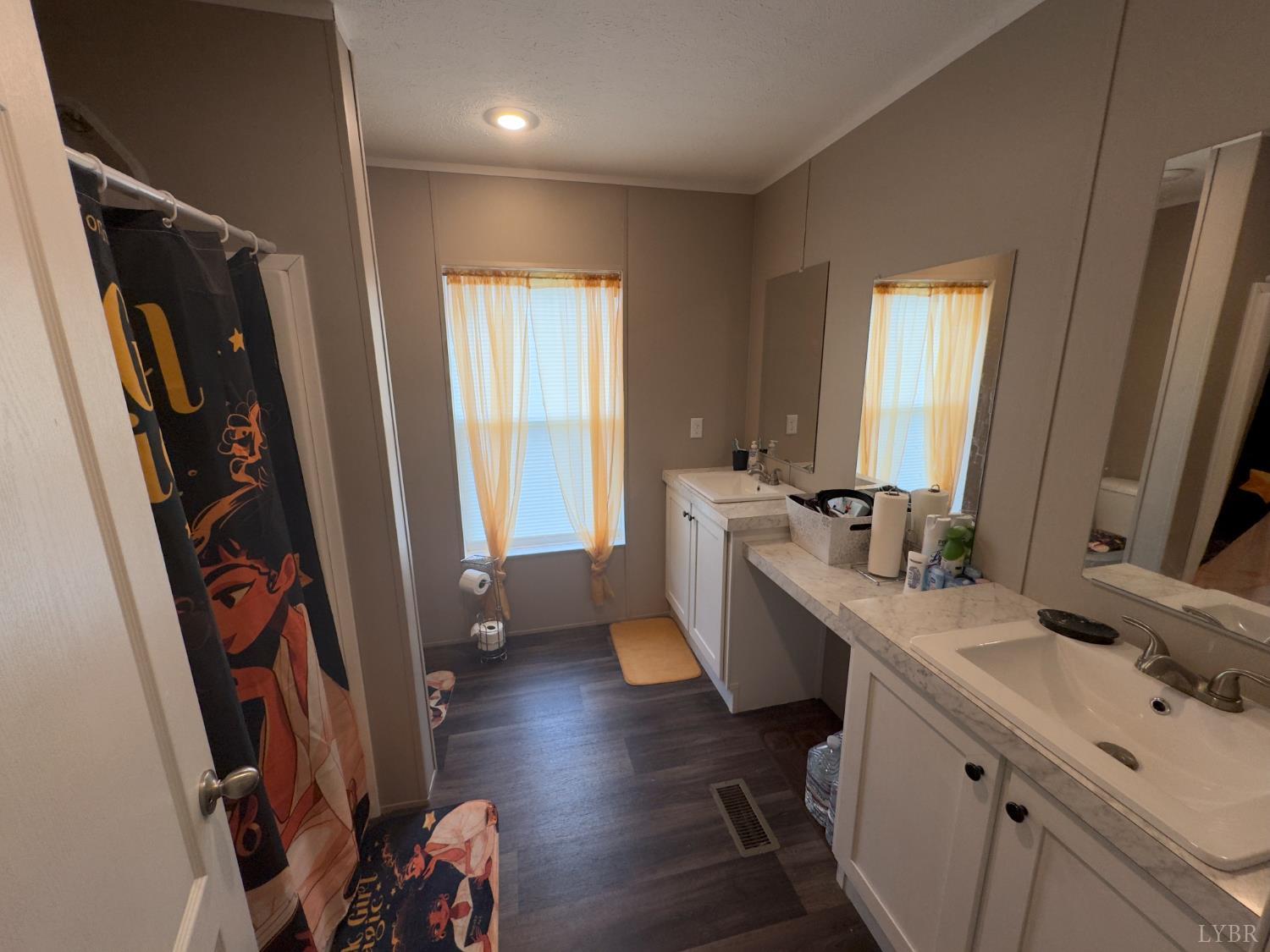 3772 Promise Land Road Appomattox, VA 24522 - Photo 17 of 28 a room with a sink a mirror and gym equipment