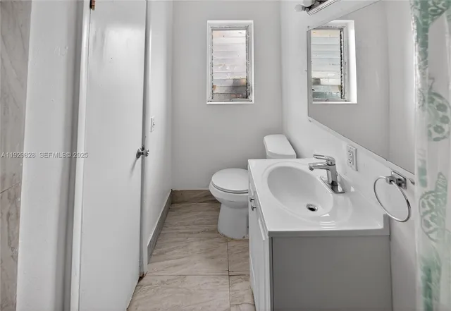 a pathway of a house with a yard