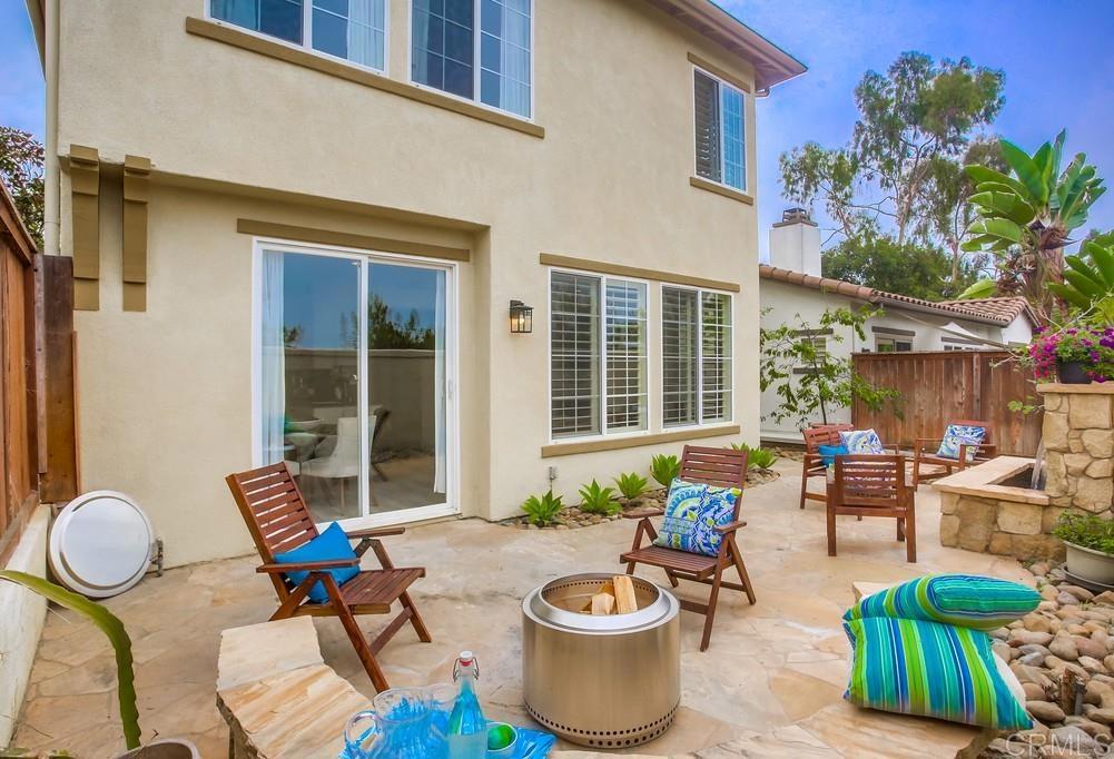 518 Beach Street Encinitas, CA 92024 - Photo 22 of 43 a view of a patio with table and chairs potted plants and a barbeque