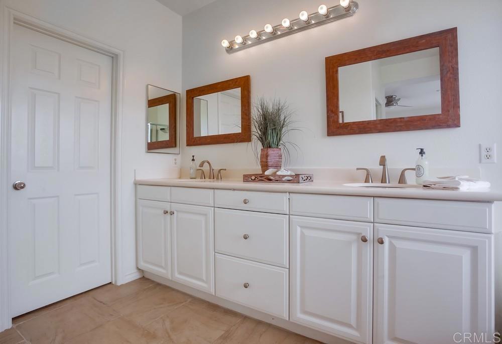 518 Beach Street Encinitas, CA 92024 - Photo 33 of 43 a bathroom with a double vanity sink and a mirror