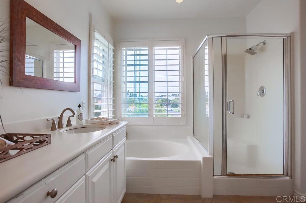 518 Beach Street Encinitas, CA 92024 - Photo 34 of 43 a bathroom with a granite countertop sink a mirror and a bathtub