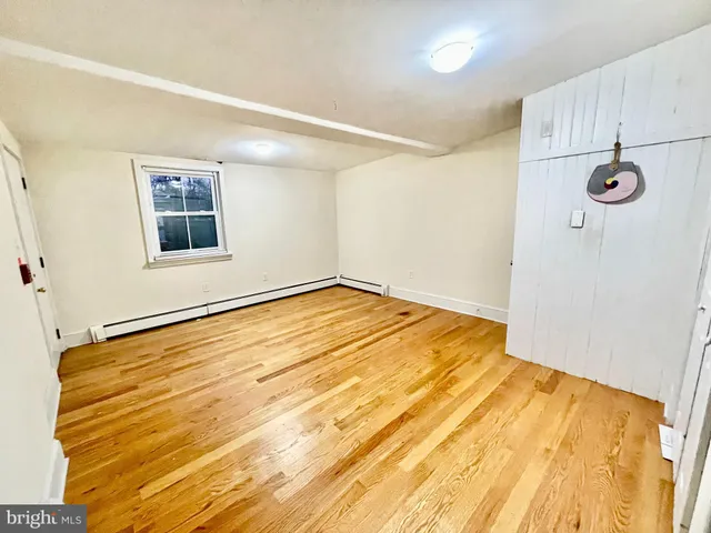 a view of a room with wooden floor and bathroom
