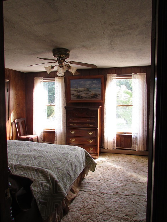 377 County Road Rochester, MA 02576 - Photo 17 of 28 a bedroom with a bed and a fireplace