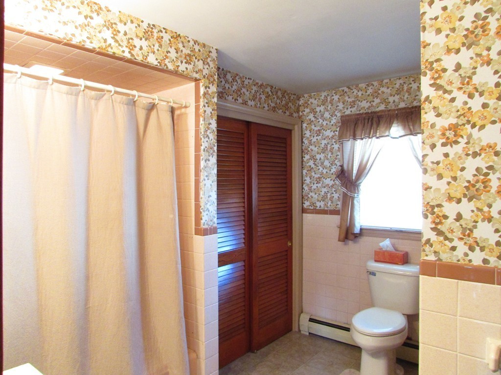 377 County Road Rochester, MA 02576 - Photo 23 of 28 a bathroom with a toilet a sink and a window
