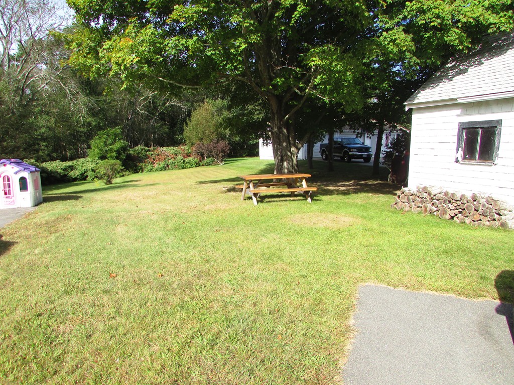 377 County Road Rochester, MA 02576 - Photo 5 of 28 a view of a swimming pool with a bench and trees around