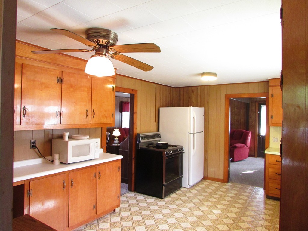 377 County Road Rochester, MA 02576 - Photo 7 of 28 a kitchen with stainless steel appliances a stove a refrigerator and a sink with granite countertops