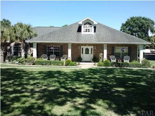 1494 Chemstrand Road Cantonment, FL 32533 - Photo 1 of 25 REFRESHING ALL ON 1.83 ACRES WITH INGROUND POOL, PLENTY OF SHADE TREES TO THE FRONT