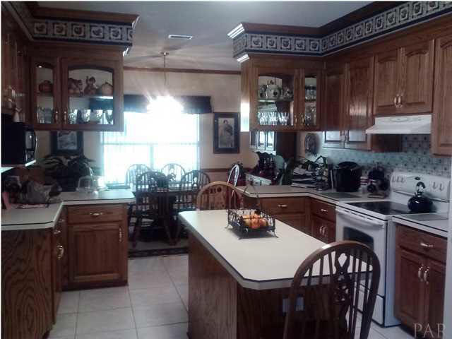 1494 Chemstrand Road Cantonment, FL 32533 - Photo 6 of 25 PLENTY OF SPACE IN THIS KITCHEN WITH ISLAND AND OAK CABINETS
