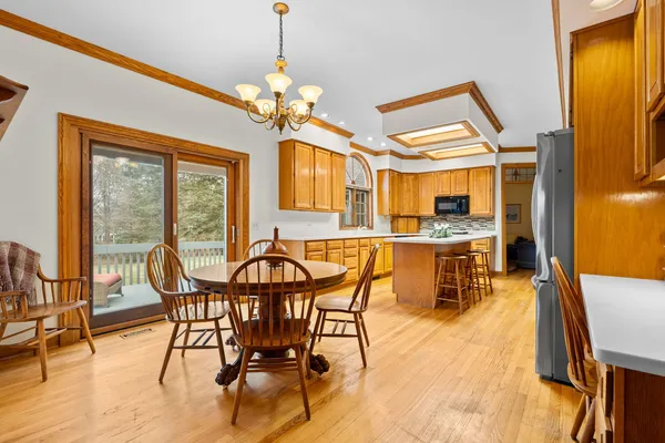 a view of a dining room with furniture and a chandelier