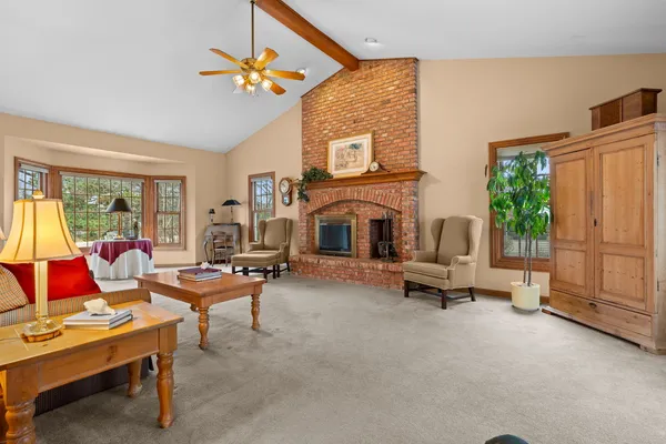 a living room with furniture a fireplace and a flat screen tv