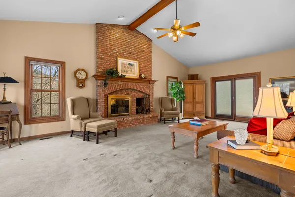 a living room with furniture a fireplace and a flat screen tv
