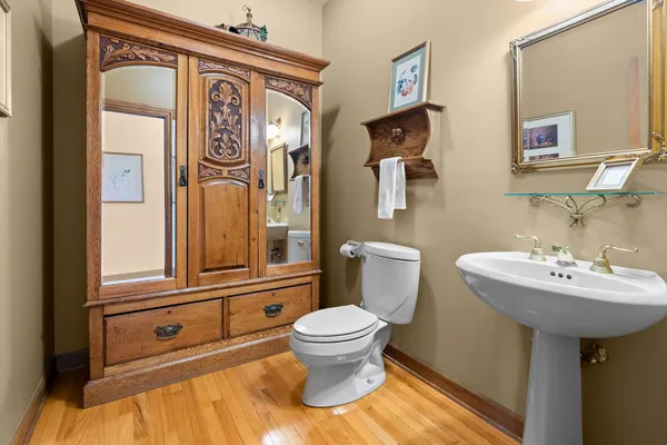 a bathroom with a sink a toilet and mirror
