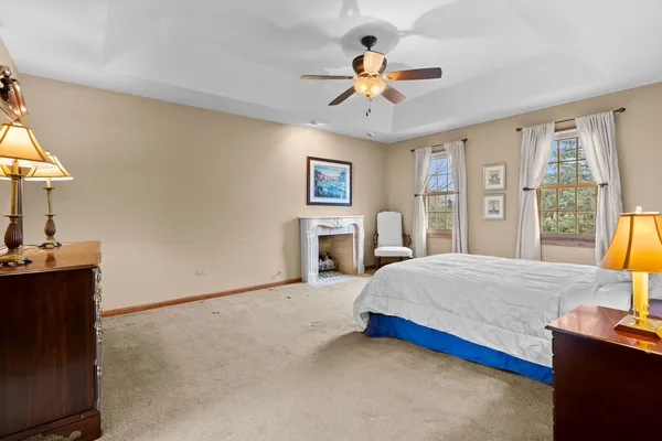 a spacious bedroom with a bed and a chandelier