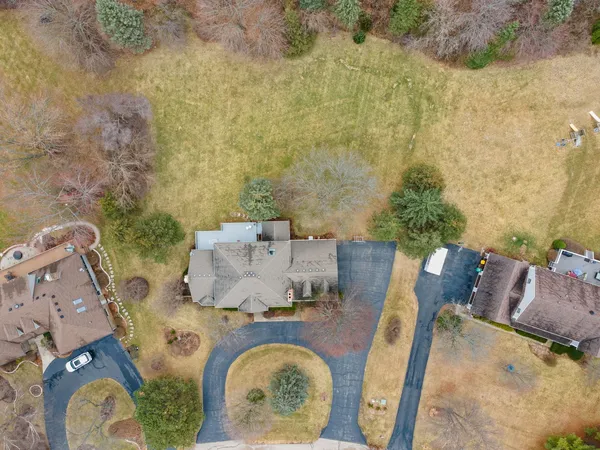 an aerial view of a house with table and chairs