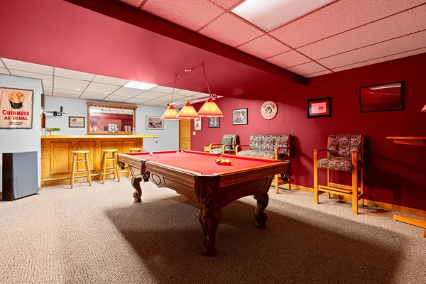 a room with table tennis pool table and chairs