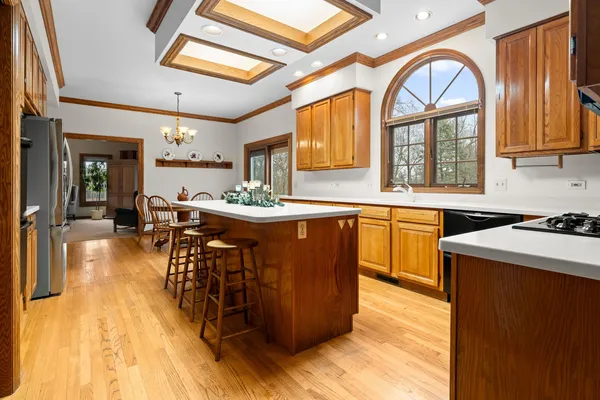 a kitchen with a sink a window cabinets and stainless steel appliances