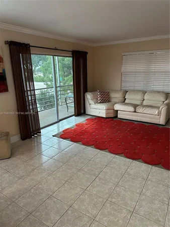 a bedroom with furniture and a floor to ceiling window
