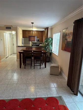 a living room with furniture and a dining table