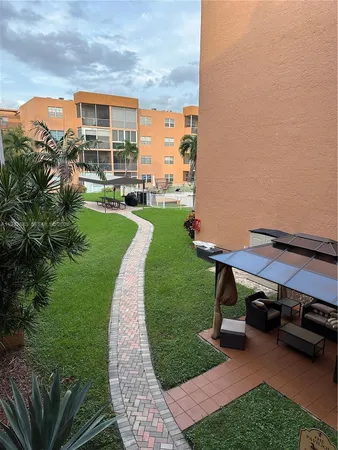 a view of a patio with table and chairs potted plants and a big yard