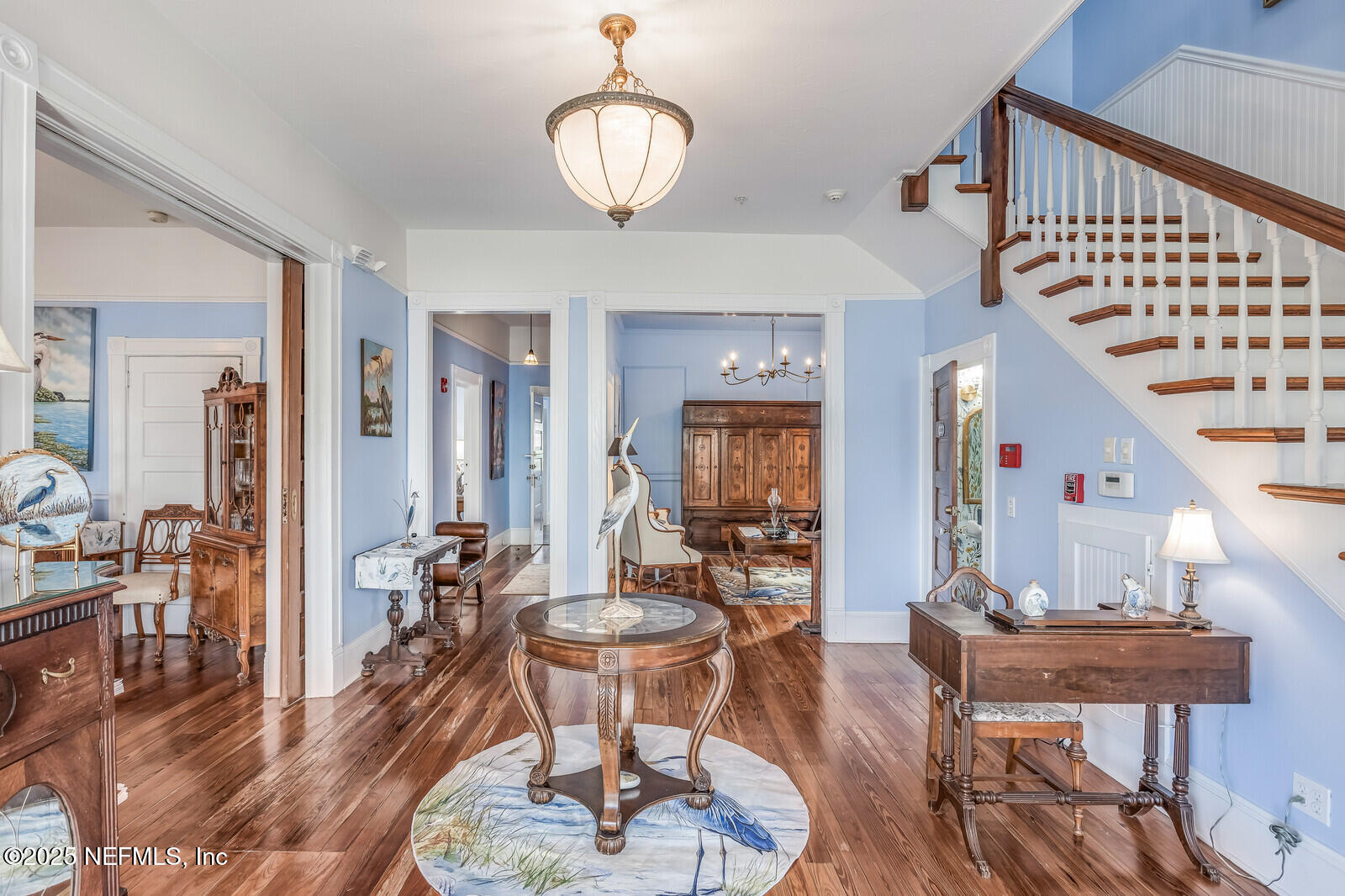 102 South 7th Street Fernandina Beach, FL 32034 - Photo 13 of 65 a living room with couches chairs and a dining table with wooden floor