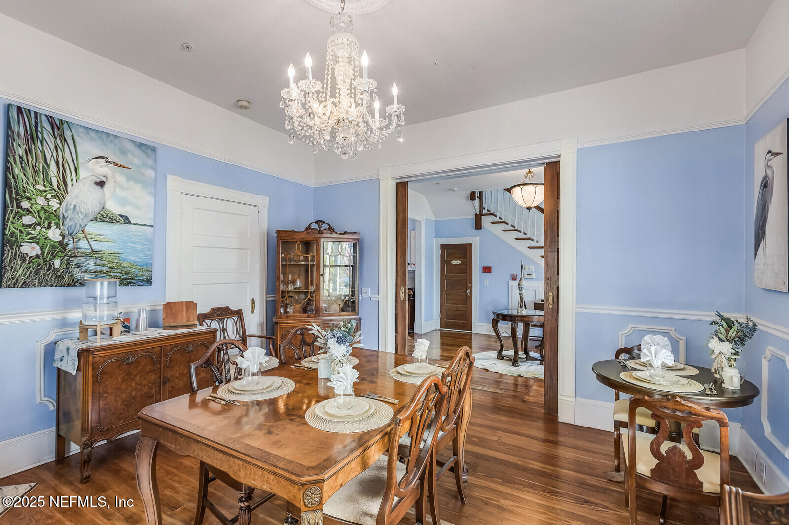 102 South 7th Street Fernandina Beach, FL 32034 - Photo 17 of 65 a view of a dining room with furniture a chandelier and wooden floor