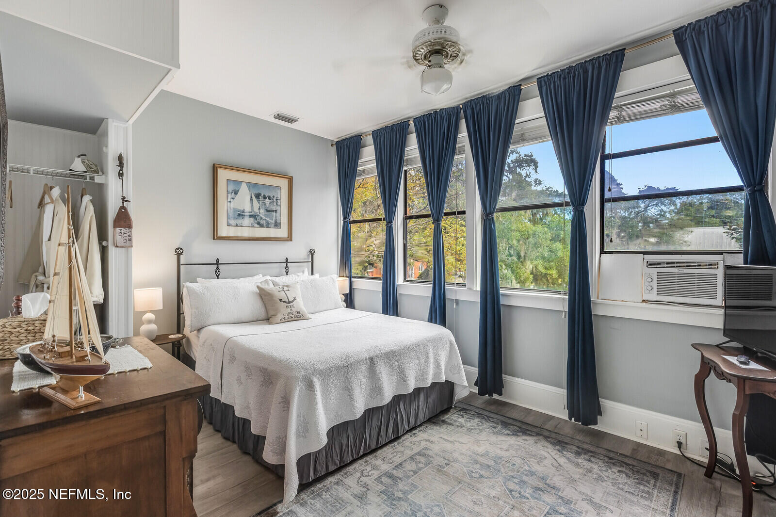 102 South 7th Street Fernandina Beach, FL 32034 - Photo 40 of 65 a bedroom with a large bed and a flat tv screen