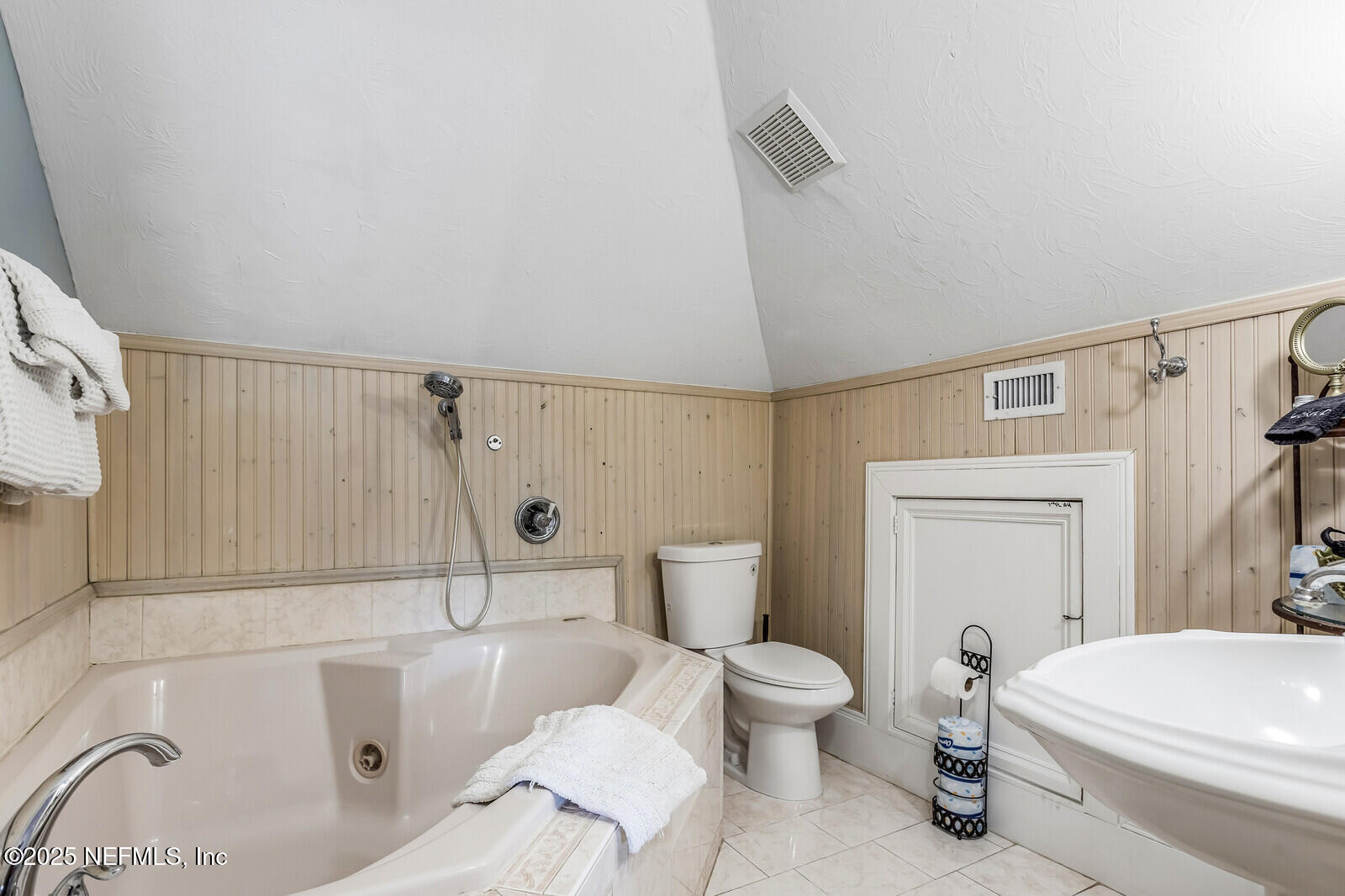 102 South 7th Street Fernandina Beach, FL 32034 - Photo 47 of 65 a white toilet sitting next to a bathroom sink and a tub