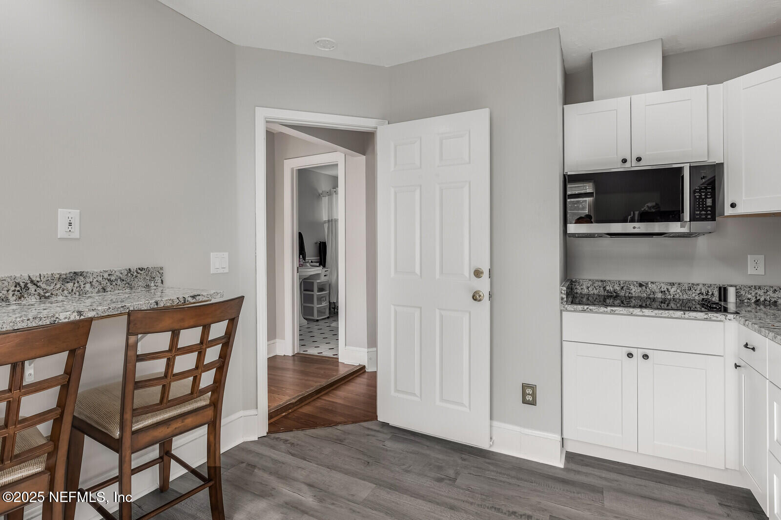 102 South 7th Street Fernandina Beach, FL 32034 - Photo 51 of 65 a kitchen with stainless steel appliances kitchen island granite countertop a stove a sink and a microwave
